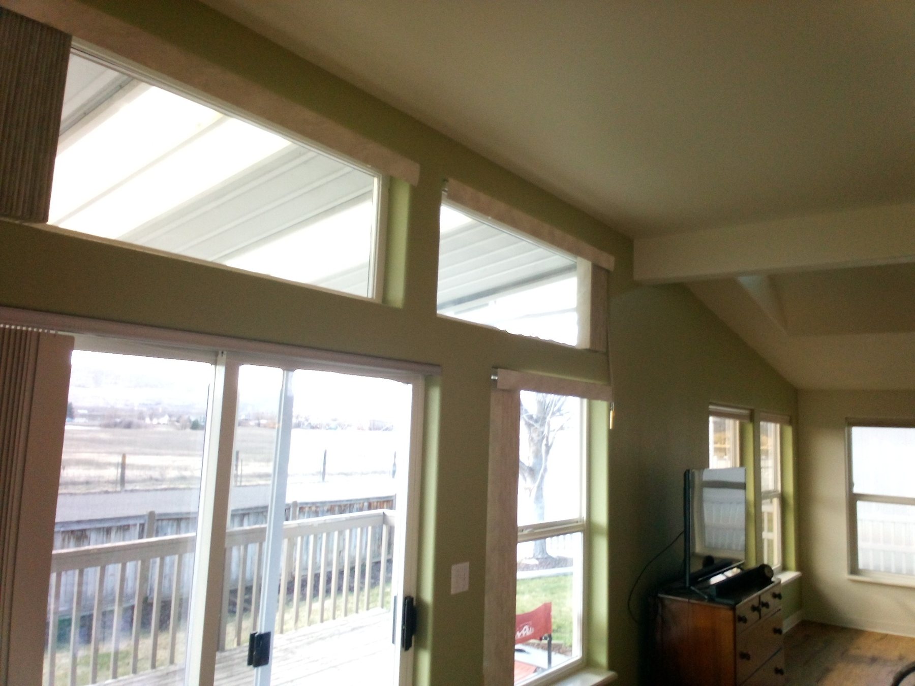 Finished interior repaint with high windows and vaulted ceiling